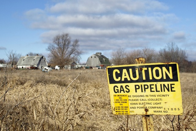 image of barns and pipeline sign