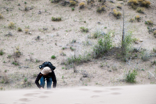 Danielle climbs up a dune